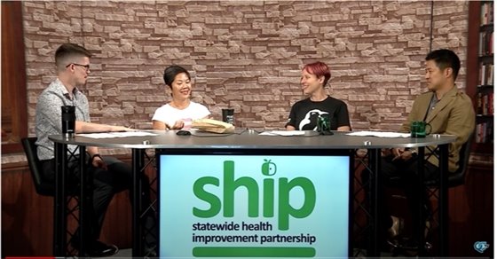 Group of People sitting around a table in a media interview