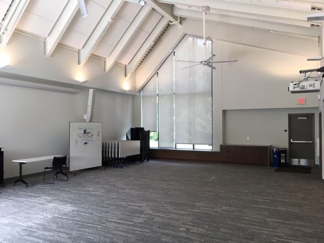 Community room--large carpeted space, vaulted ceilings, natural light