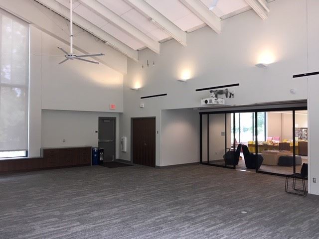 Back corner of community room--projector visible from ceiling, along with library entrance
