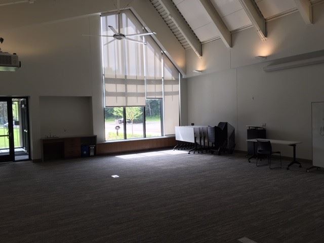 sink, windows, folded up tables in community room