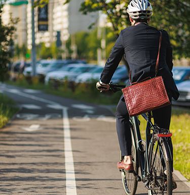 Man biking to work on a path